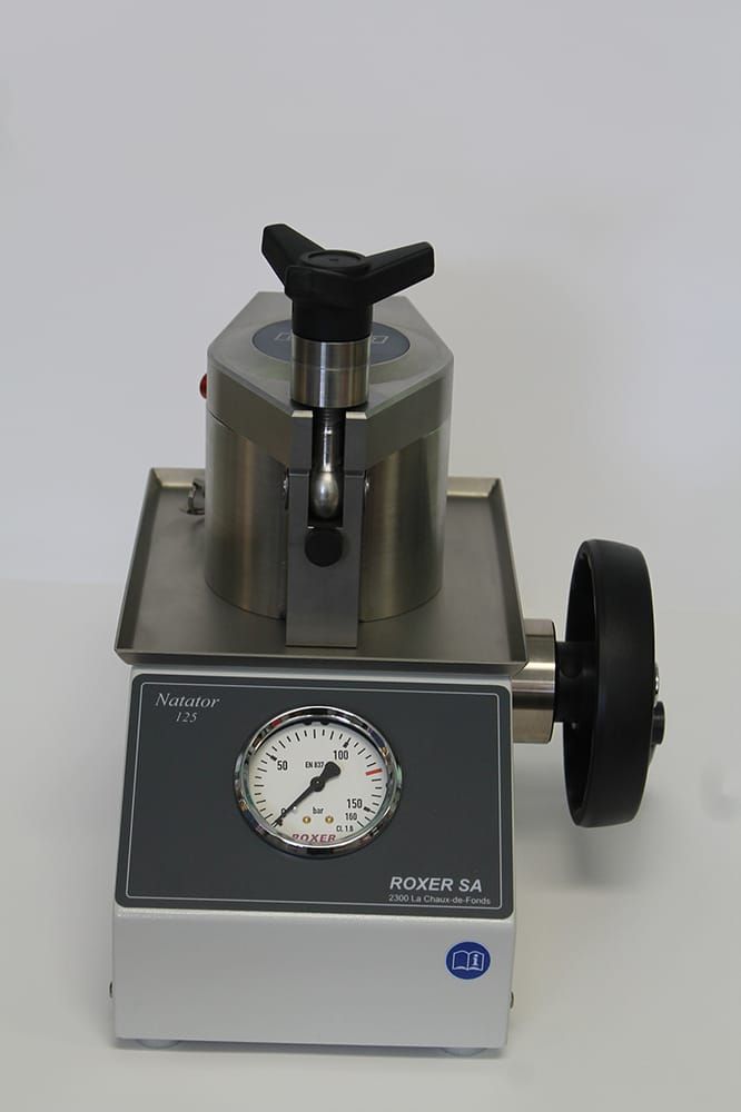 A Roxer Natator water-resistance tester with a pressure gauge